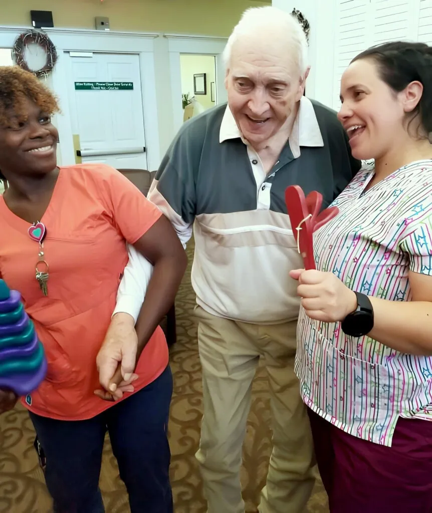 Team members celebrating with a resident at Barton House
