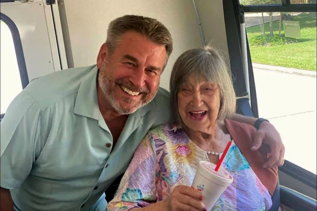 A resident and team member on an outing bus at Novellus Clairemont