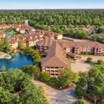 Show photo 7: Aerial view of the buildings and pond at The Terraces at Kingwood