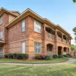 Show photo 8: The lawn and building at The Terraces at Kingwood