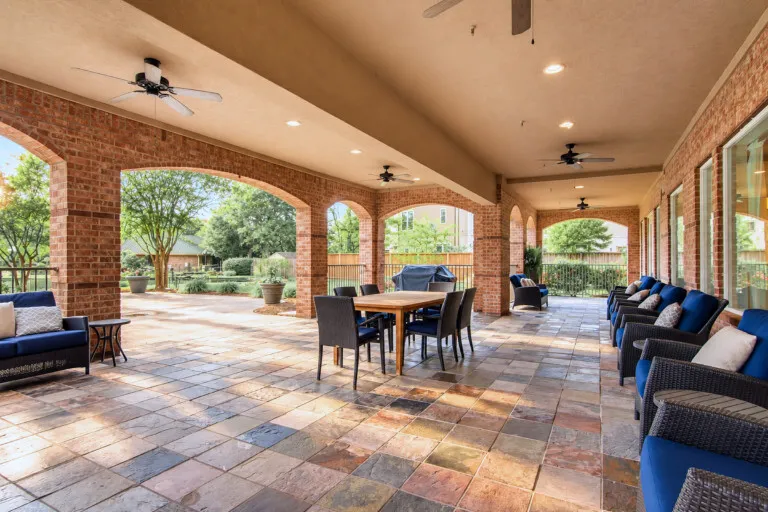 The covered patio with brick arches at The Terraces at Kingwood