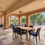 Show photo 12: Dining tables on the covered patio at The Terraces at Kingwood