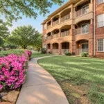 Show photo 16: A garden walkway beside the building at The Terraces at Kingwood
