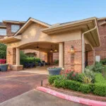 Show photo 4: The covered front entrance at The Terraces at Kingwood