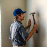 Show photo 63: Maintenance hanging artwork for a resident