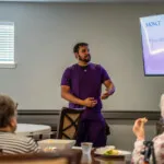 Show photo 101: A presenter talking with residents