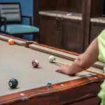 Show photo 95: A resident lining up a billiards shot