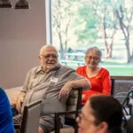 Show photo 100: Residents enjoying a presentation together