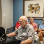 Show photo 105: Residents listening to piano music