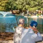 Show photo 27: Two residents looking out at the pond