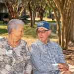 Show photo 19: Two residents relaxing by the pond