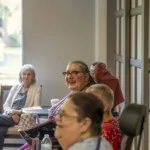 Show photo 81: Residents sharing a laugh at a social gathering
