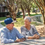Show photo 23: Two residents sitting together by the pond