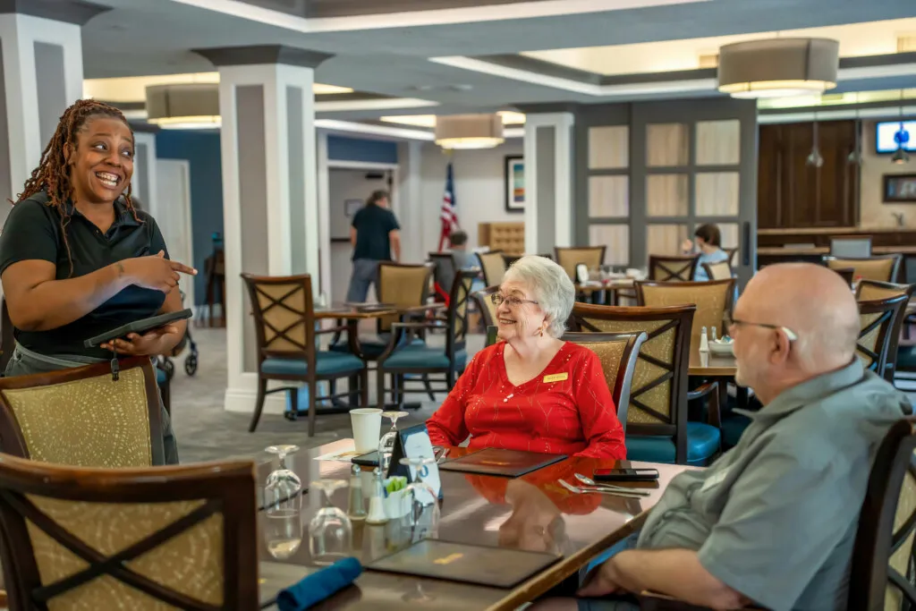 A server chatting with residents at lunch