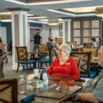 Show photo 33: A server chatting with residents at lunch