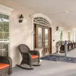 Show photo 9: Covered front porch with rocking chairs at Tarina of Cypresswood