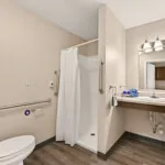 Show photo 33: Accessible bathroom with grab bars and a walk-in shower in a residence at Tarina of Cypresswood