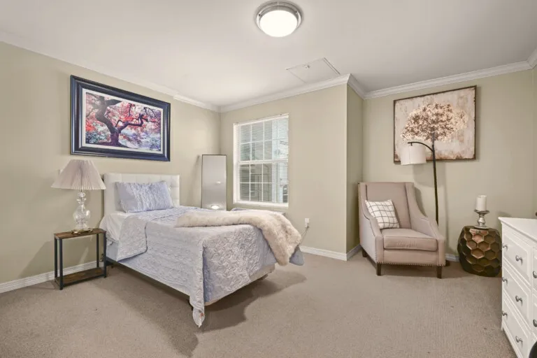 Furnished residence bedroom with an armchair at Tarina of Cypresswood