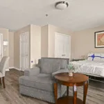 Show photo 31: Residence sitting area with an armchair and side table at Tarina of Cypresswood