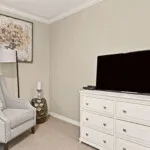 Show photo 34: Residence sitting corner with an armchair and dresser at Tarina of Cypresswood